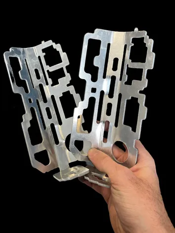 The waterjet-cut cage after bending, held in hand.